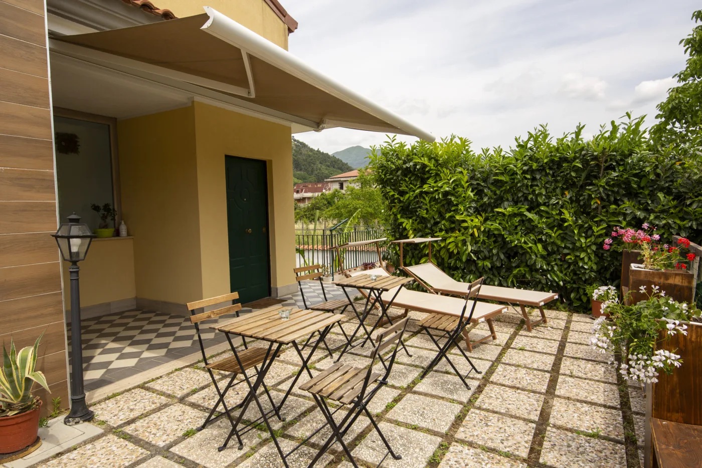 Outdoor area with tables, seating and greenery
